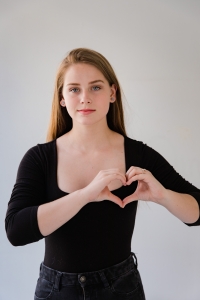 woman making a heart sign with her hands